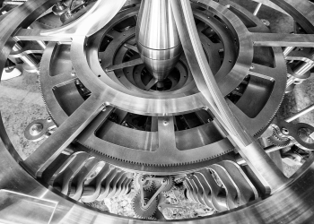 A black-and-white image of a clock's inner workings.