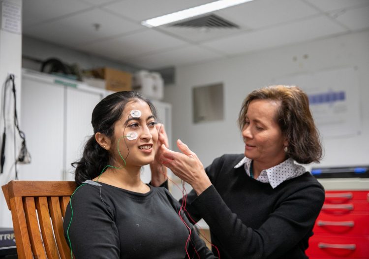Image: Swinburne University, Kameneva putting a tVNS electrode on the ear of a participant