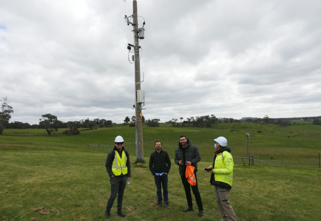 Researchers at Victoria University installing the new devices on electricity poles.
