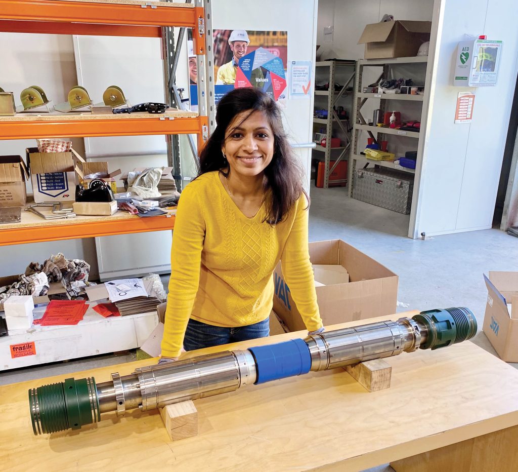 mechanical engineer Sravani Mukkisa standing with her DrillMax tool