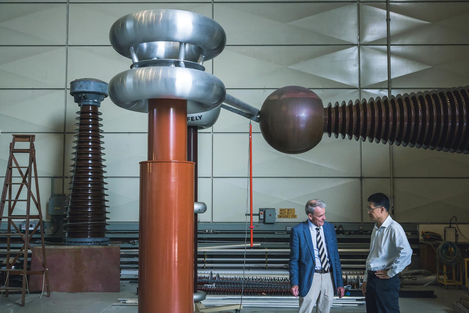 Inglis (left) and a colleague in front of a high voltage divider.