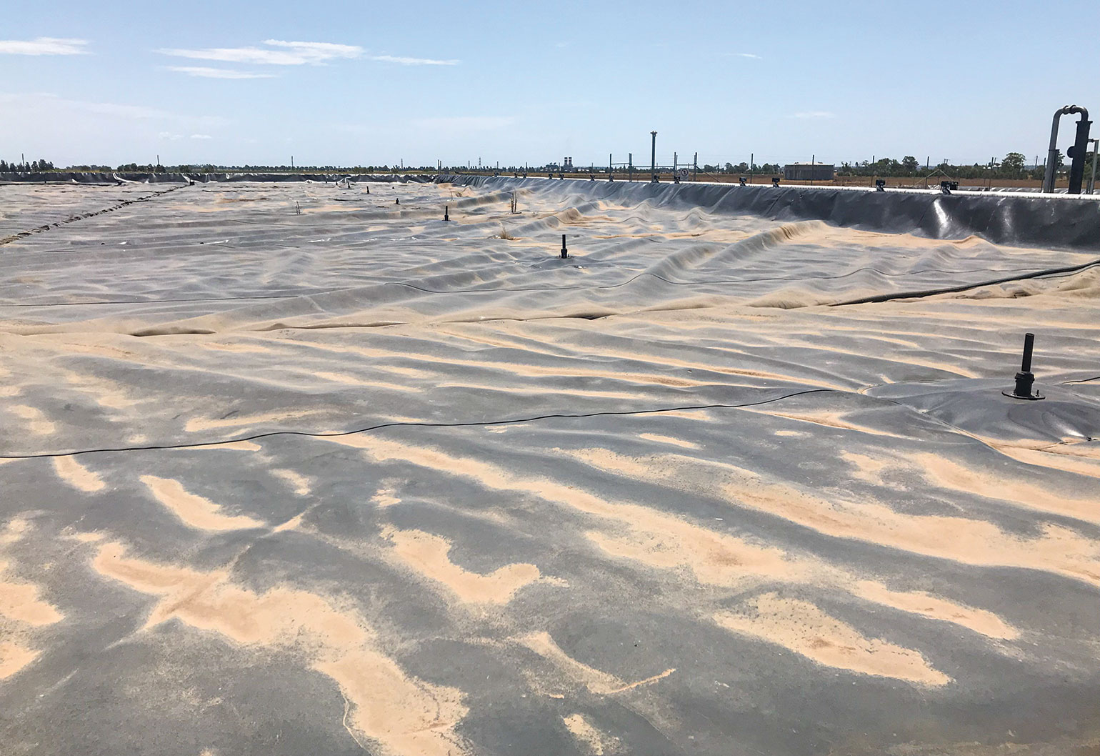 Bacteria produce biogas in this covered lagoon