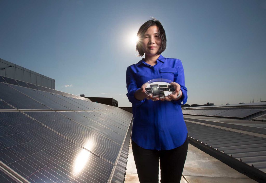 Xiaojing Hao holding the highly efficient kesterite solar cells.