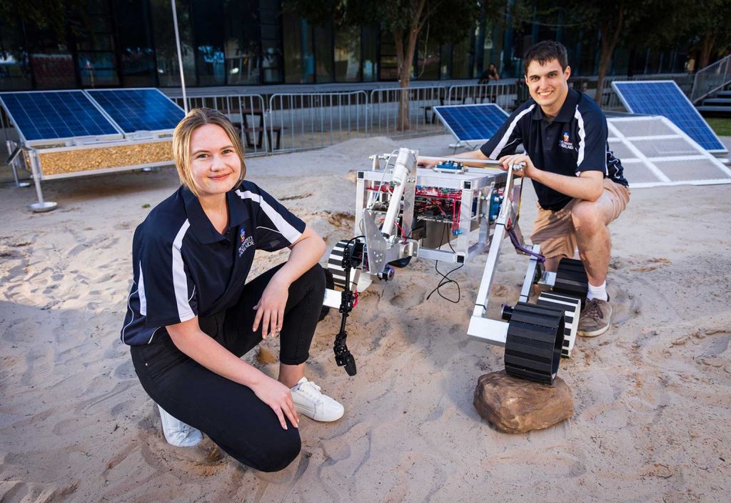 Bachelor of Mathematical and Computer Science student Abigail Sparnon and PhD candidate Henry Mellor with the University of Adelaide's rover. (Image: James Elsby)