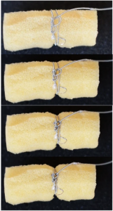 An image of the smart suture tired around a sponge. 
