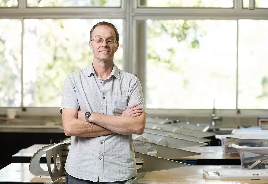 STEM teacher Adrian Casten standing in his Burnside State High School classroom