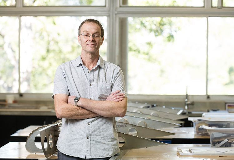 STEM teacher Adrian Casten standing in his Burnside State High School classroom