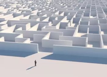Ethics in engineering - seen from above, a small lone figure stands before an enormous white maze.