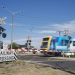 A commuter train passes through a railway level crossing on Eel Race Road, Seaford, Melbourne. Stock Photo