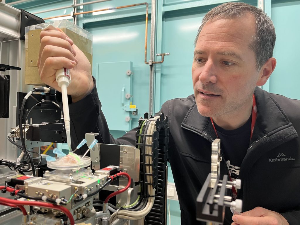 Image of Associate Professor Martin Donnelley working on the synchrotron in a lab environment.