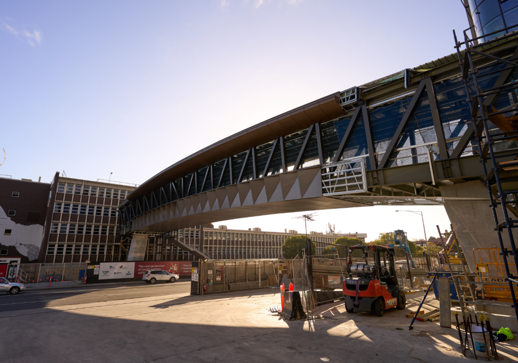 A from-below view of a pedestrian bridge under construction.