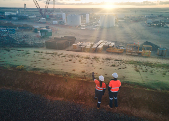 A pair of workers look out over the Waitsia Gas Project.